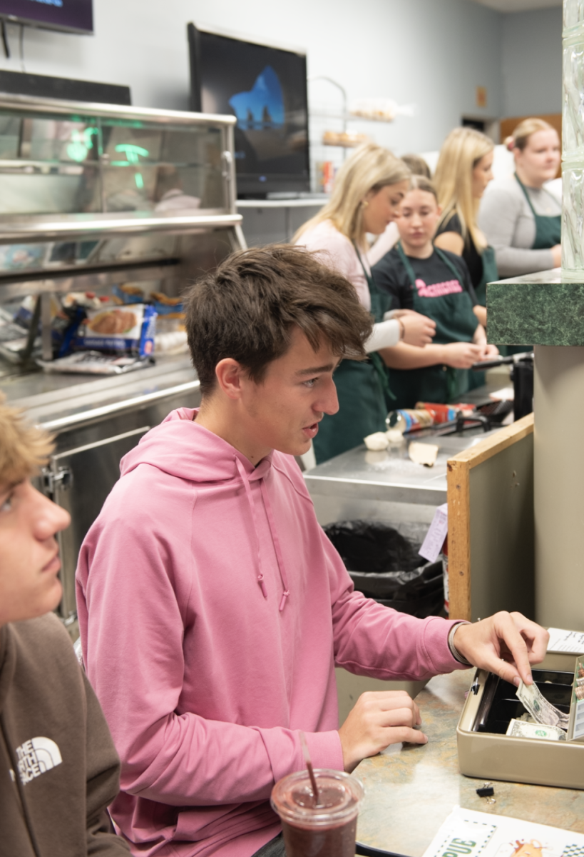 10.24.24 Senior Drake Tourtlottte taking orders at The Pub on pink day. 